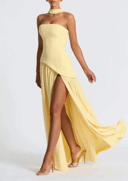 Women's strapless maxi dress with high slit and draped sash, yellow, side view showing the slit