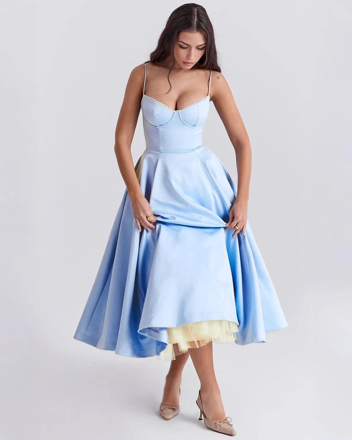 Women's sweetheart midi dress with fitted bodice and full skirt, light blue, lifting the skirt