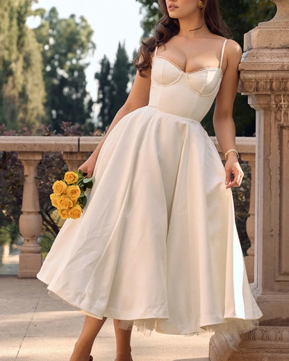 Women's sweetheart midi dress with fitted bodice and full skirt, white, styled outdoors