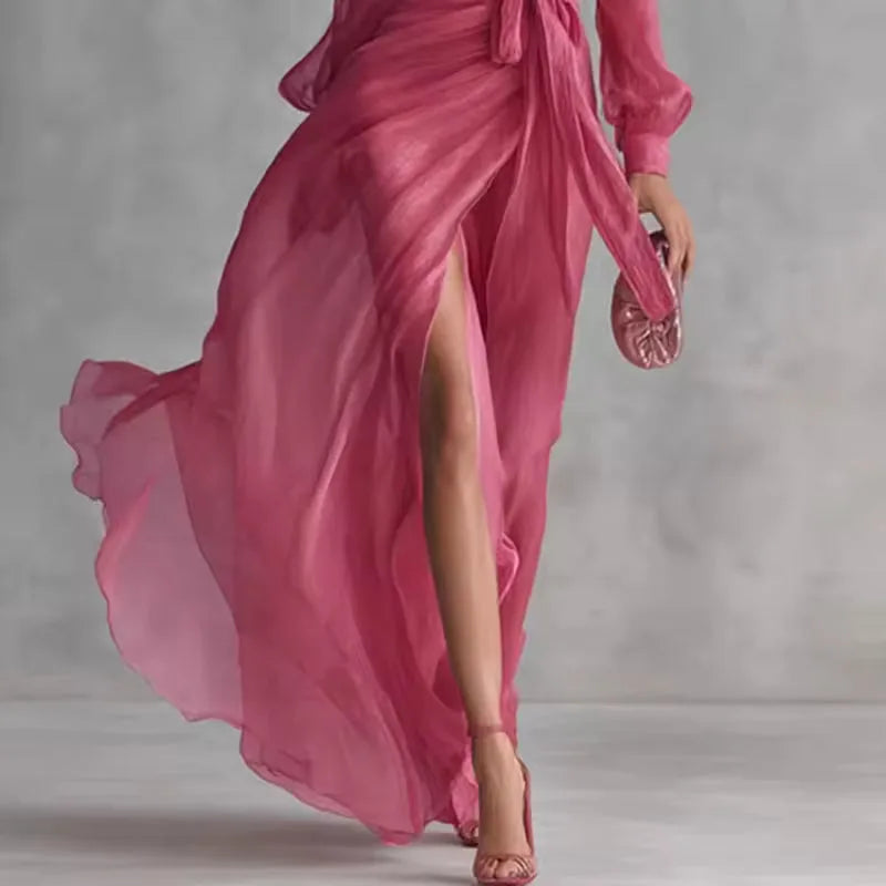 Women's pink V-neck wrap maxi dress with belt and slit, side view showing the slit