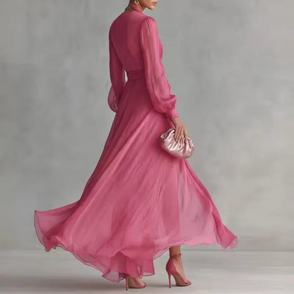 Women's pink V-neck wrap maxi dress with belt and slit, skirt in motion
