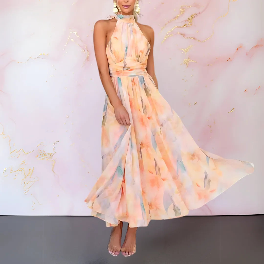 Women's watercolor print halter maxi dress with open back, skirt in motion