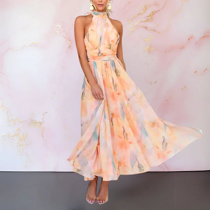 Women's watercolor print halter maxi dress with open back, skirt in motion