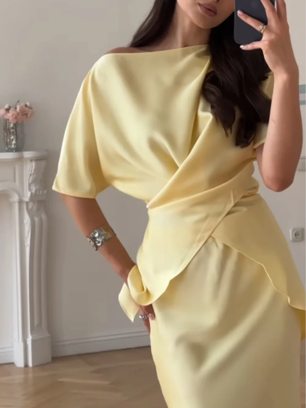 Women's yellow off-shoulder wrap top and long skirt set, close-up of the draped top