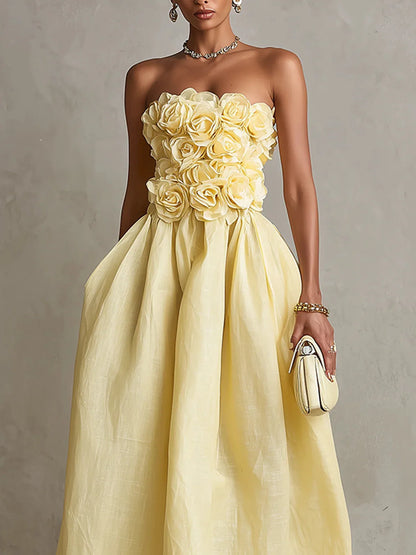Women's yellow strapless midi dress with 3D flower bodice, close-up of the 3D flower bodice