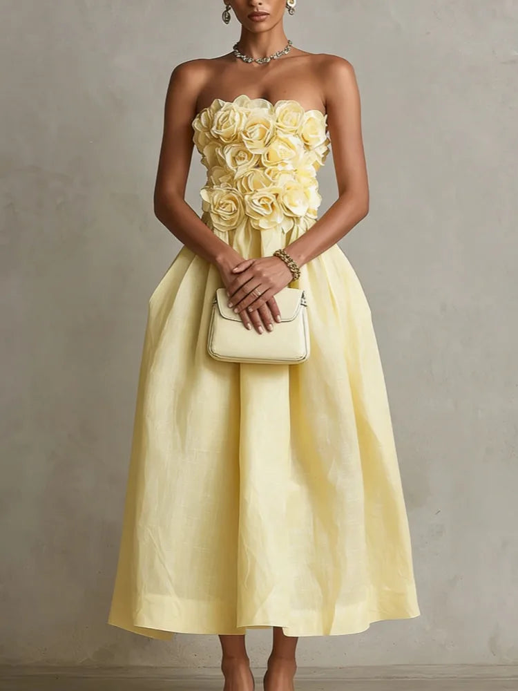 Women's yellow strapless midi dress with 3D flower bodice, front view with handbag